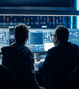 Two Professional IT Programers Discussing Blockchain Data Network Architecture Design and Development Shown on Desktop Computer Display. Working Data Center Technical Department with Server Racks Two Professional IT Programers Discussing Blockchain Data Network Architecture Design and Development Shown on Desktop Computer Display. Working Data Center Technical Department with Server Racks